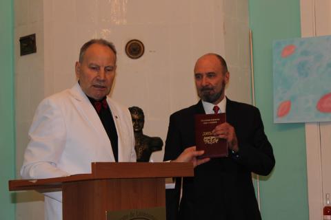 Academy Moscow chapter VP Vlad Krasnoyarskiy dealing out regalia